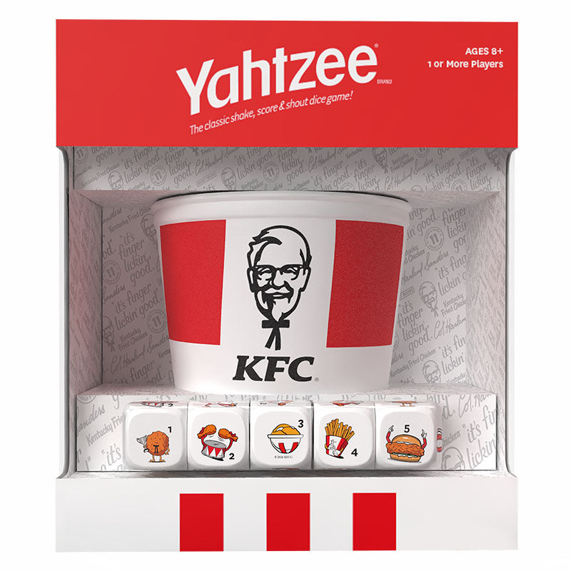KFC branded Yahtzee dice game set in retail packaging, featuring a white bucket-style die cup with red KFC stripes and logo, plus five illustrated dice showing food and chicken-themed icons.