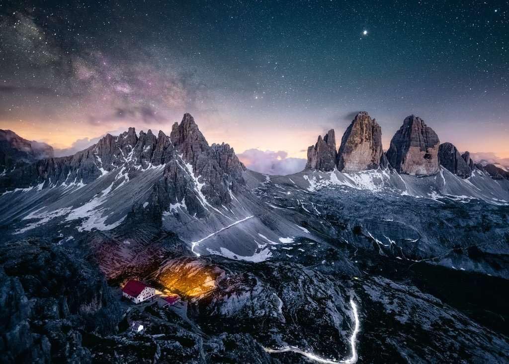 ravensburger jigsaw puzzle image  Mountain landscape with illuminated buildings under a starry sky