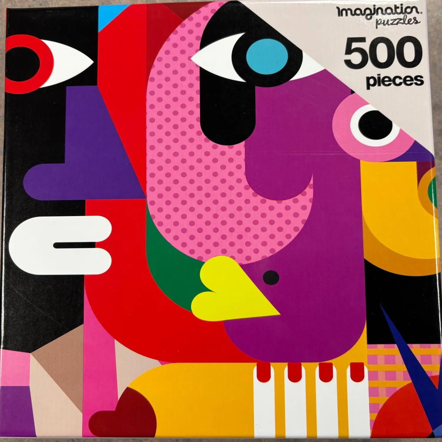colorful artistic puzzle box image of faces.  500 pieces