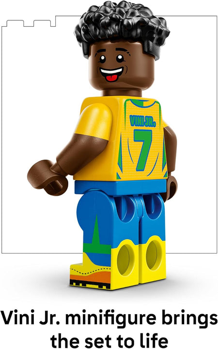 LEGO minifigure of a vini jr. wearing a yellow jersey with blue shorts on a white background.