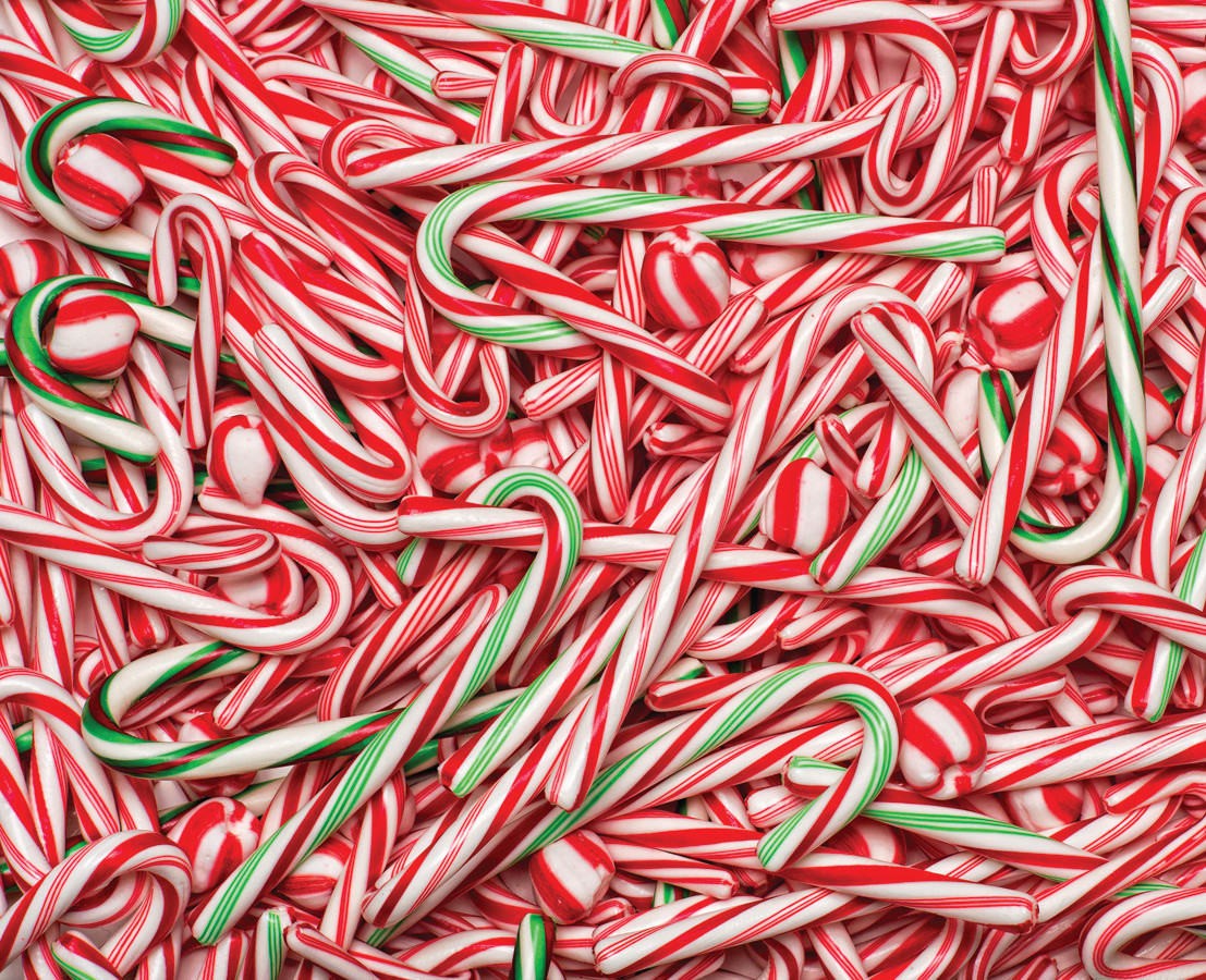 Vermont Christmas Company 1000-piece puzzle of a pile of red and white candy canes with green stripes.