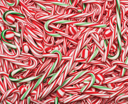 Vermont Christmas Company 1000-piece puzzle of a pile of red and white candy canes with green stripes.