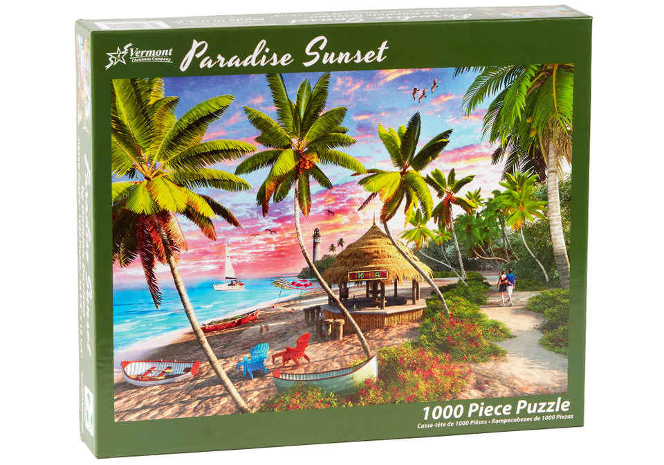 Vermont Christmas Company 1000-piece Jigsaw puzzle box featuring a tropical scene with palm trees and a sunset.