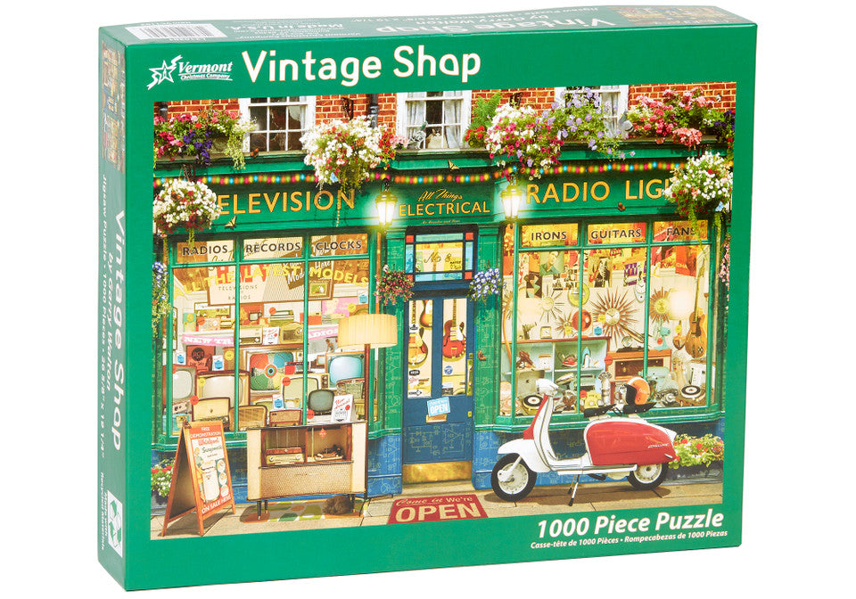 Vermont christmas company 1000-piece Jigsaw puzzle box featuring a vintage shop scene with a scooter and colorful storefront.