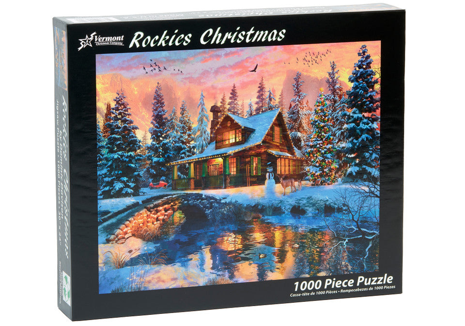 Vermont christmas company 1000-piece Jigsaw puzzle box featuring a winter scene with a cabin and trees, labeled 'Rockies Christmas'.