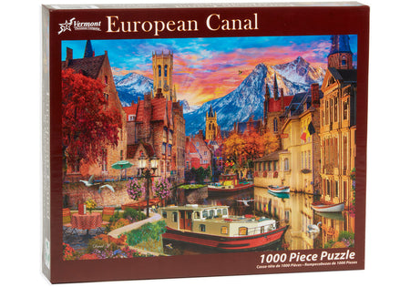 vermont christmas company 1000-piece Jigsaw puzzle box featuring a scenic European canal with mountains and buildings.