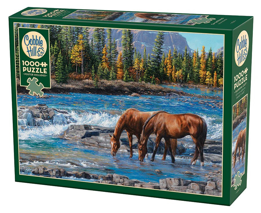 Cobble Hill 1000-piece jigsaw puzzle box with two horses by a river and mountain background