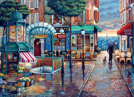 Cobble Hill 1000-piece jigsaw puzzle of a vibrant city street in Paris with cafes, shops, and a person walking with an umbrella.