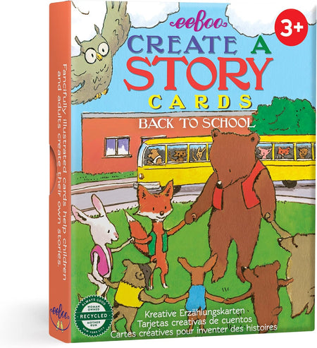 Front and spine view of a children's card deck box titled 'eeboo Create a Story Cards Back to School' with colorful cartoon animals, a yellow school bus, and a red '3+' age badge on a white background.