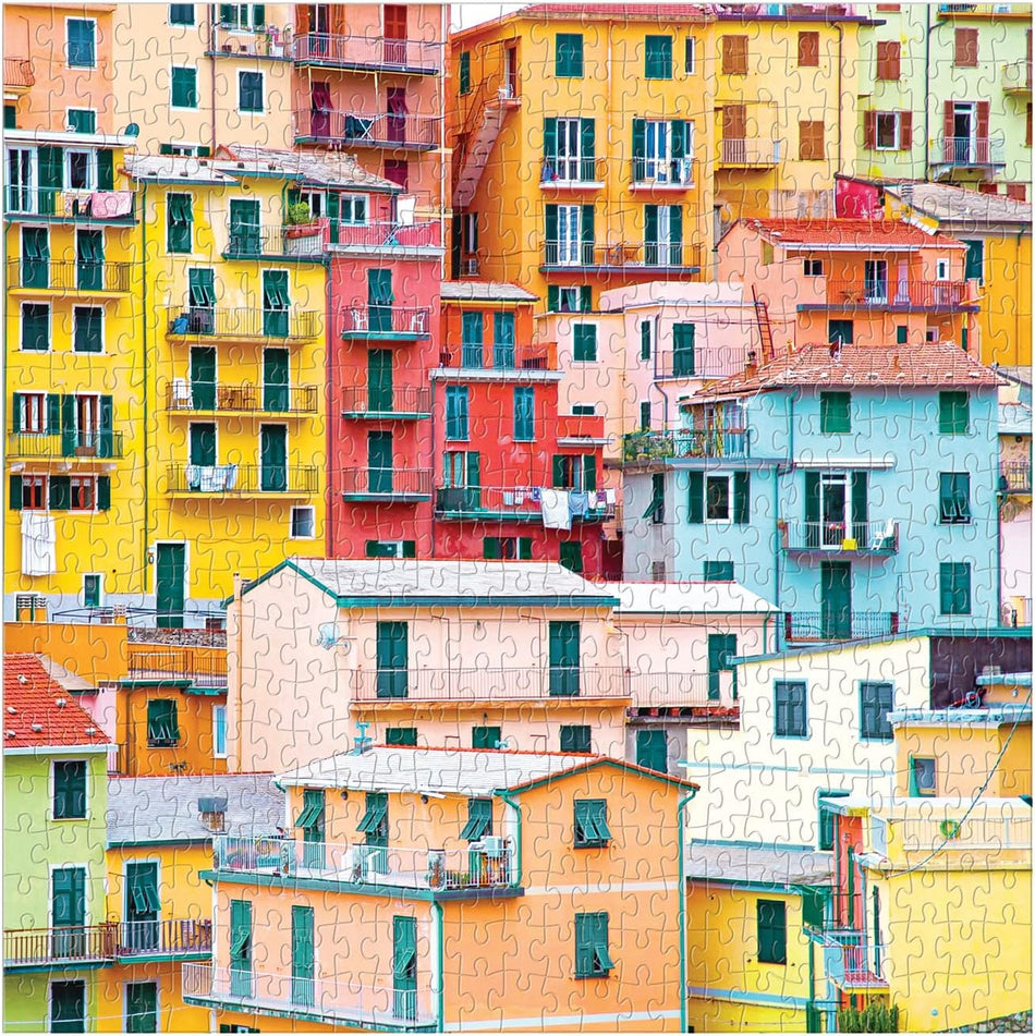A colorful 500-piece jigsaw puzzle from galison titled "ciao from cinque terre" showing a dense hillside village with brightly painted buildings in yellow, orange, pink, blue, and cream tones.