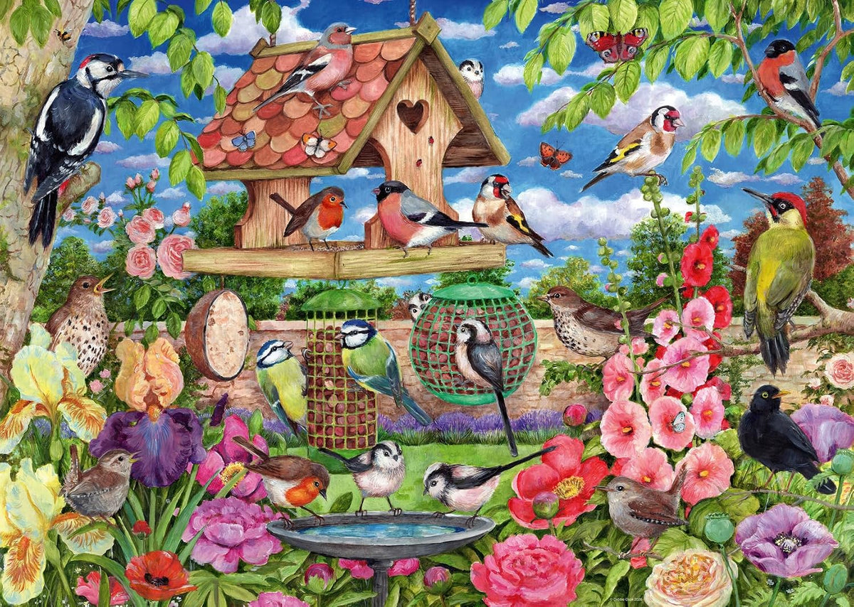 ravensburger a bird's banquet (the bird table) jigsaw puzzle of a Colorful garden scene with birds, flowers, and a birdhouse.