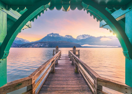ravensburger footbridge lac d'annecy jigsaw puzzle of Wooden pier leading to a lake with mountains in the background during sunset.