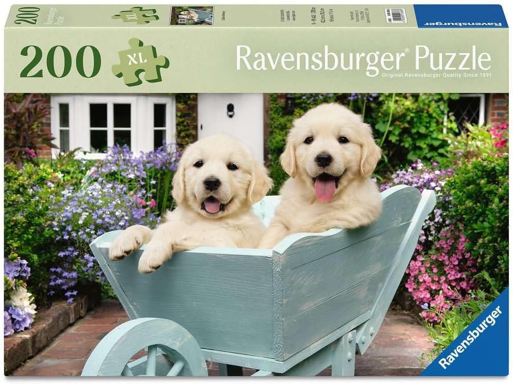 Ravensburger puzzle box with two puppies in a wheelbarrow against a garden background