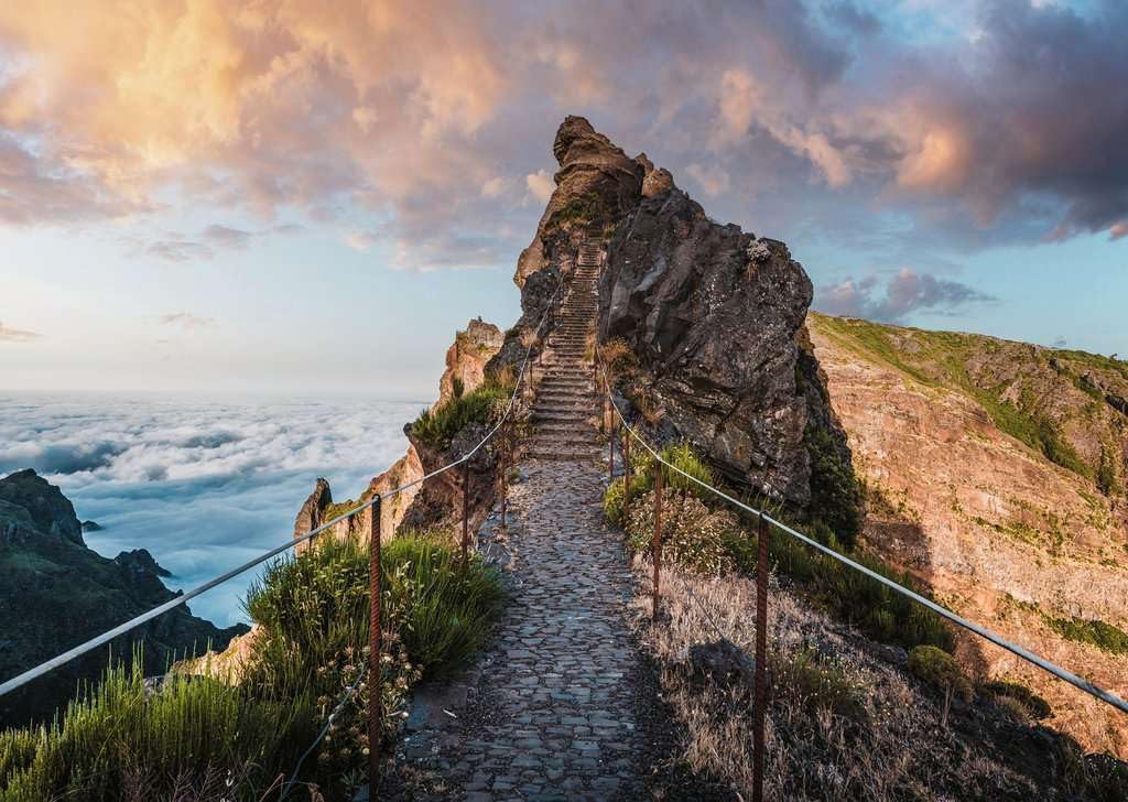 ravensburger pathway to heaven jigsaw puzzle of Stairway leading up a rocky cliff with a scenic view of clouds and mountains.