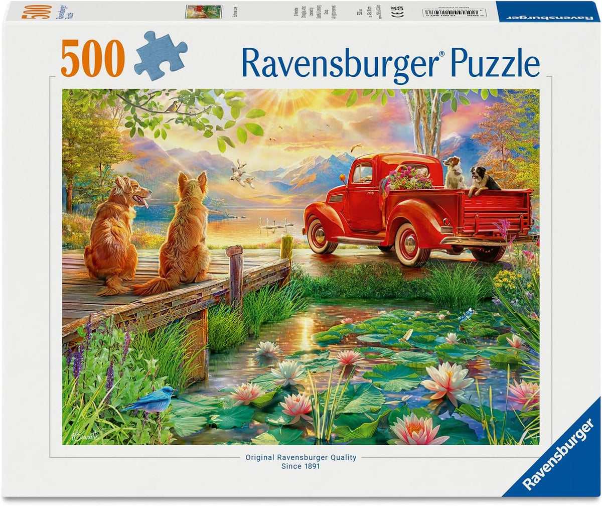 Ravensburger puzzle packaging with a scenic design of dogs by a pond and red truck.
