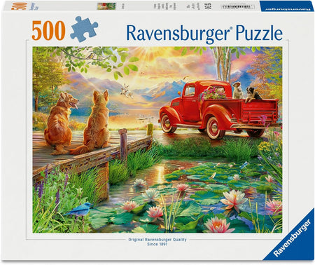 Ravensburger puzzle packaging with a scenic design of dogs by a pond and red truck.