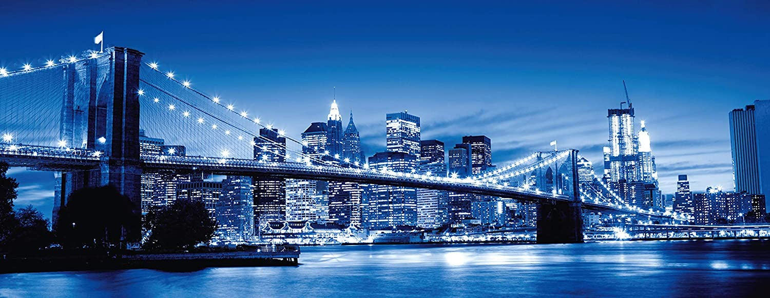 Ravensburger twilight new york jigsaw puzzle depicting a panoramic view of New York City at twilight with the Brooklyn Bridge prominently featured.