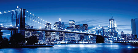 Ravensburger twilight new york jigsaw puzzle depicting a panoramic view of New York City at twilight with the Brooklyn Bridge prominently featured.