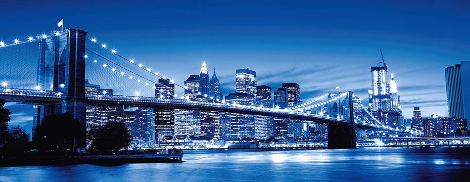 Ravensburger twilight new york jigsaw puzzle depicting a panoramic view of New York City at twilight with the Brooklyn Bridge prominently featured.